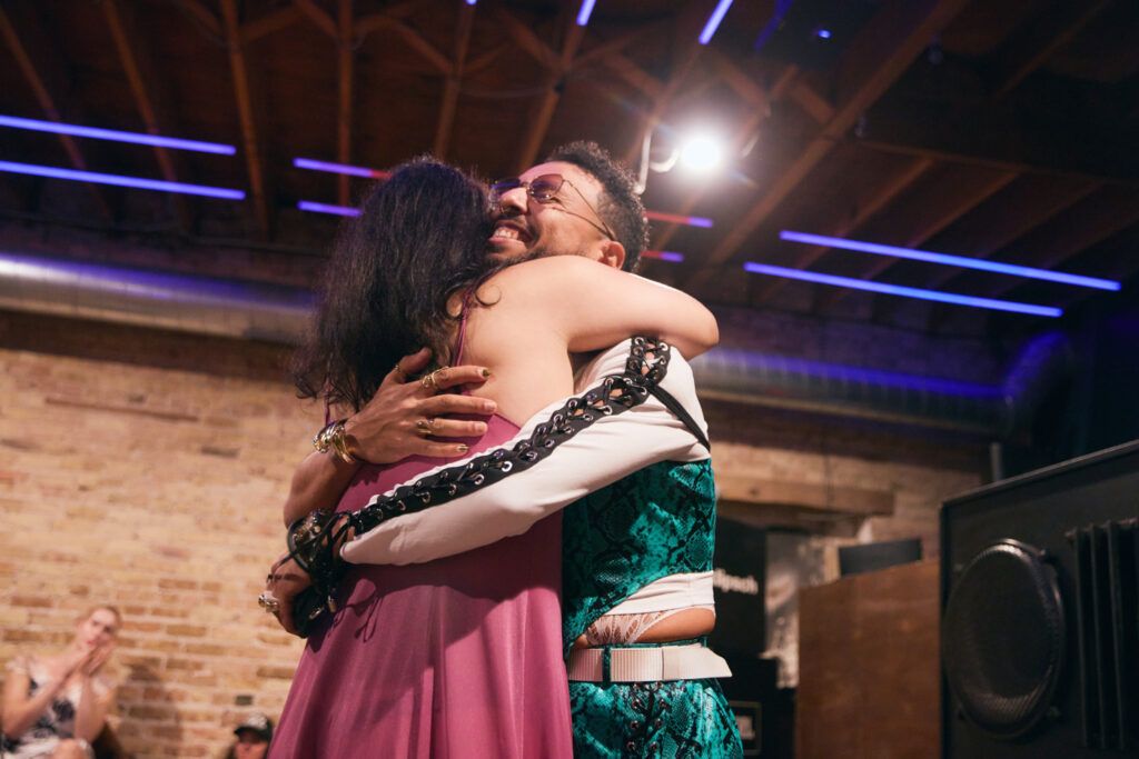 Two artists hugging in between sets.