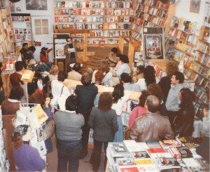 Historical image of a group of people attending a poetry reading at Guild Books in 1984.